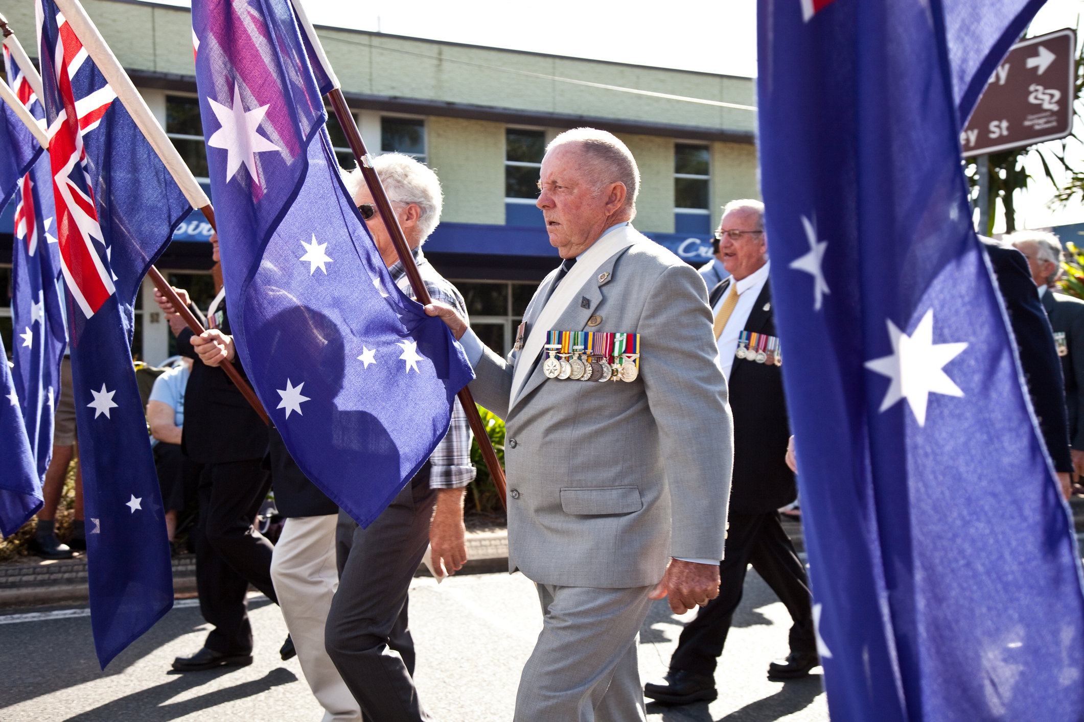 Servicemen marching on Anzac Day with Australian Flags