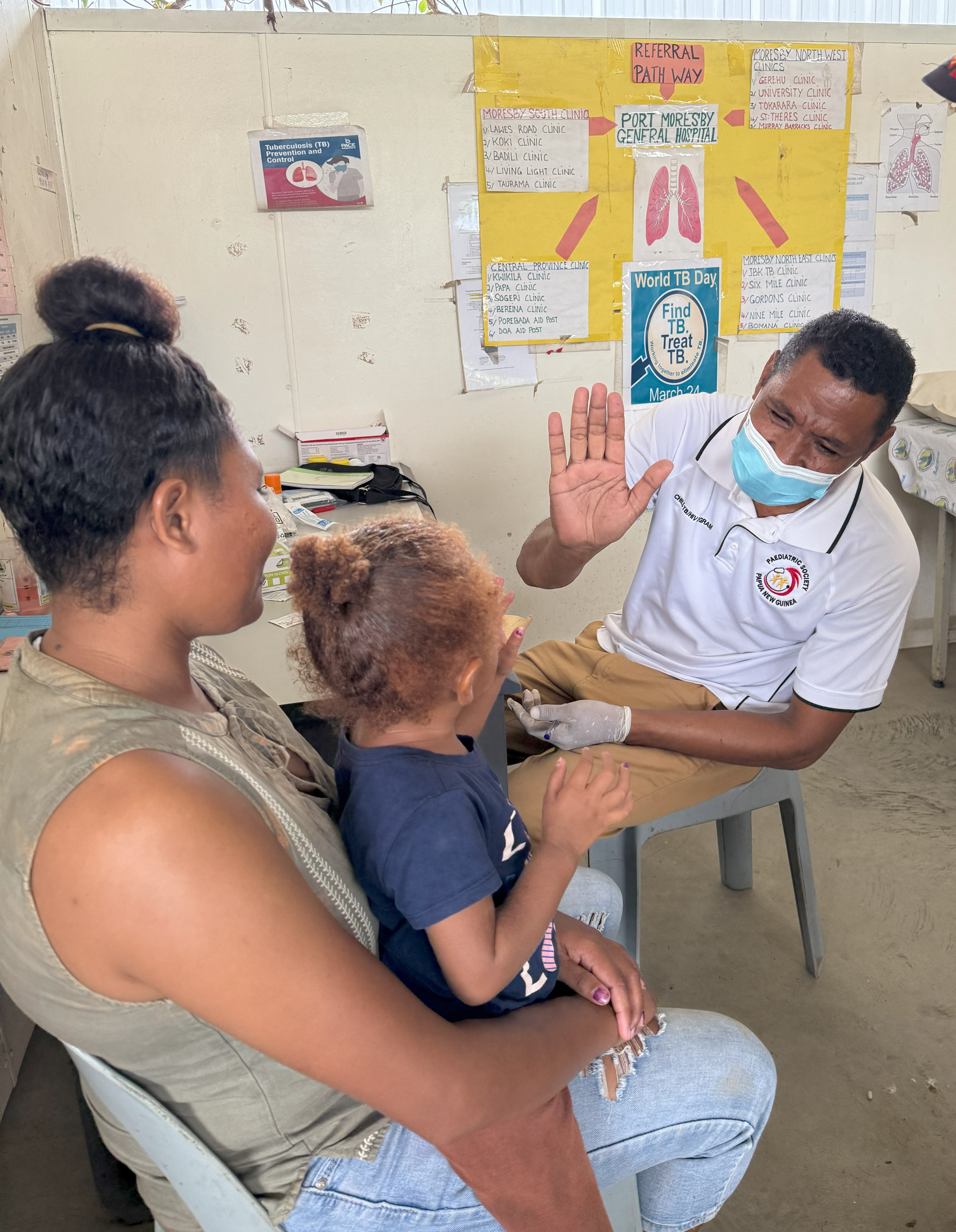 Honeu Bomiringke giving a high five to a nursing officer