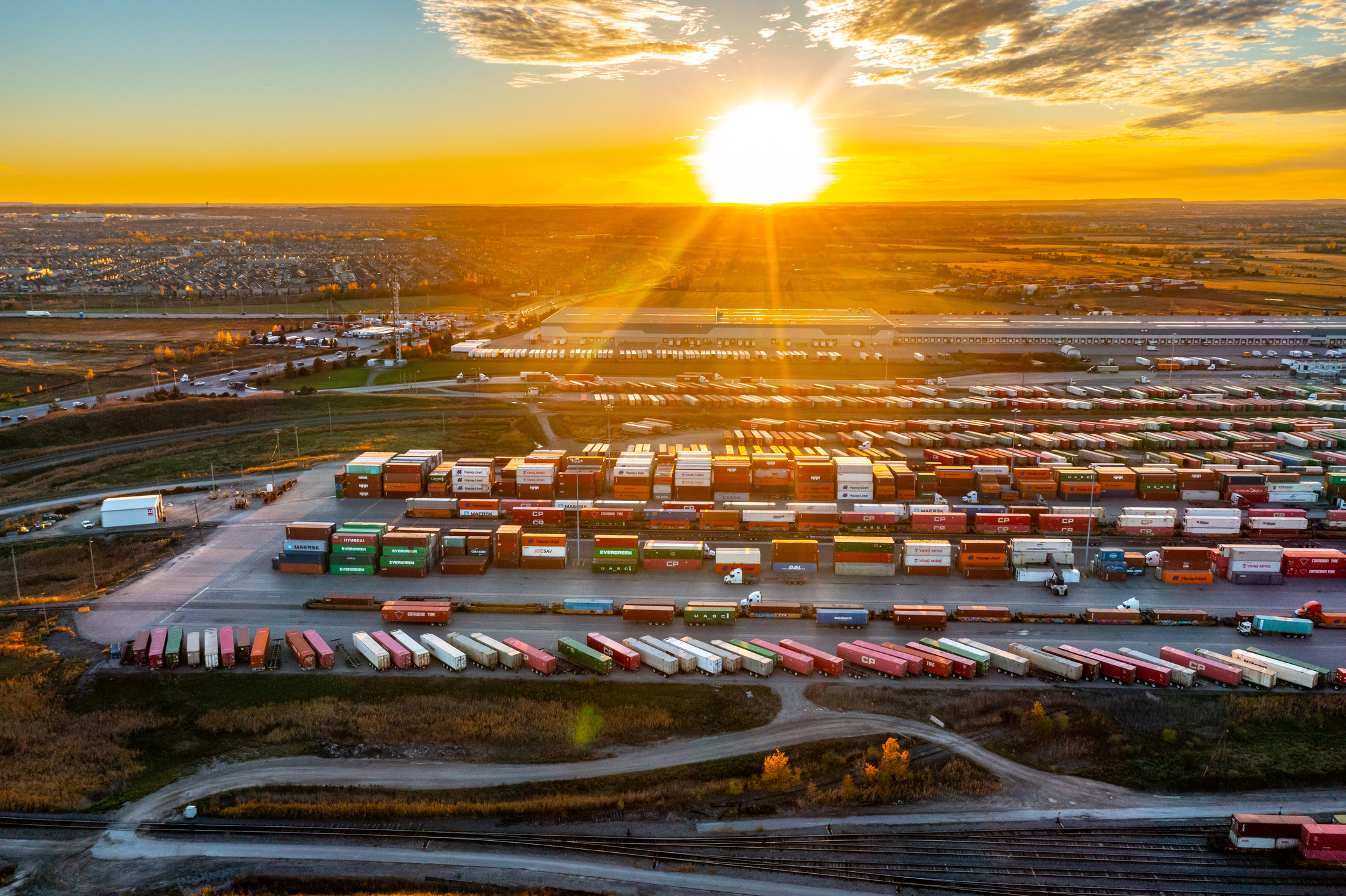 sunset over a lot full of storage containers
