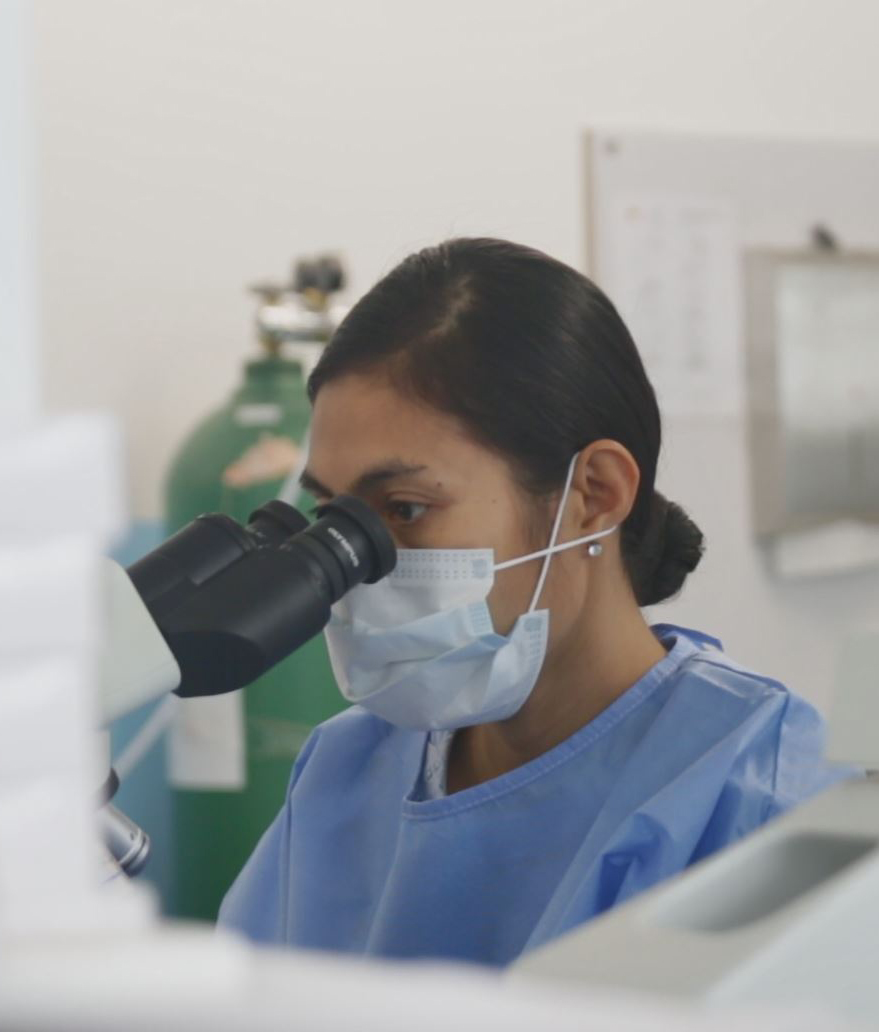 doctor looking through a microscope
