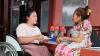 a woman in a wheelchair talking to another woman