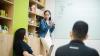women talking in front of a whiteboard