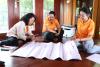 three women brainstorming during workshop writing on poster