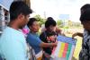 Woman in Fiji pointing to a chart labeled 'Disaster Response Plan'
