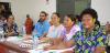 People in Fiji sitting at a table smiling during a workshop on education